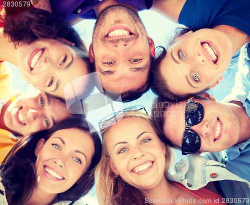 Image of group of teenagers looking down