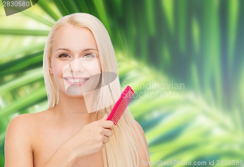 Image of smiling woman with hair brush