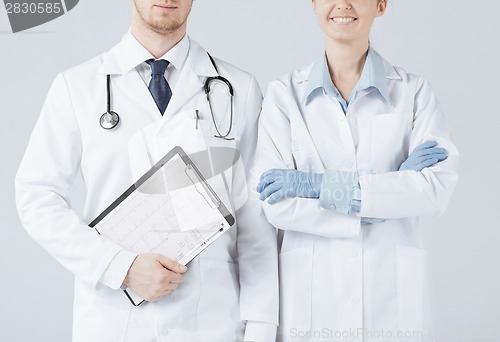 Image of nurse and male doctor holding cardiogram