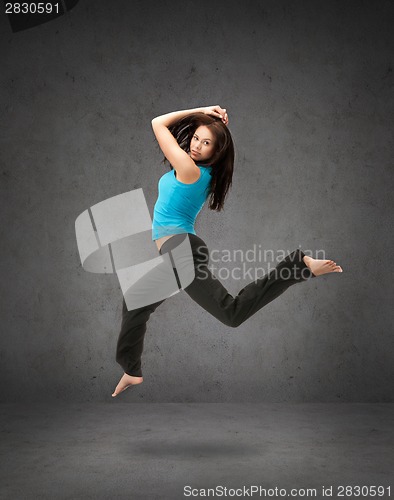 Image of beautiful sporty woman jumping in sportswear