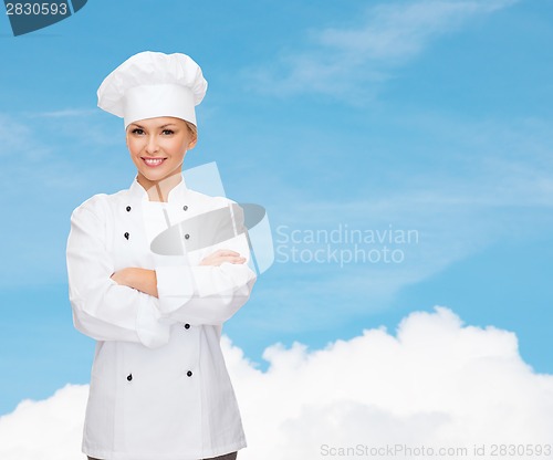 Image of smiling female chef with crossed arms