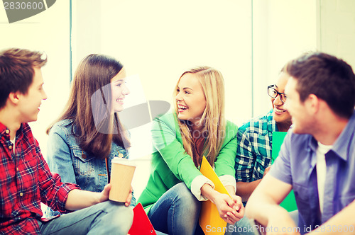 Image of students communicating and laughing at school