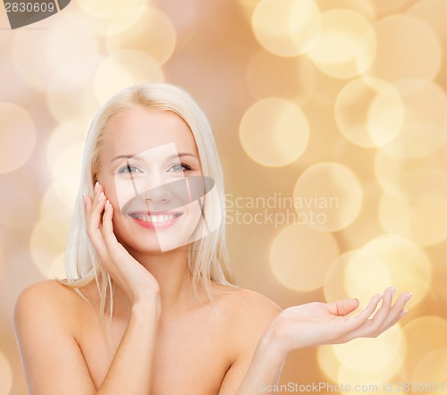 Image of smiling woman holding imaginary lotion jar