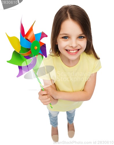 Image of smiling child with colorful windmill toy