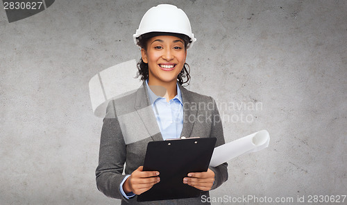Image of businesswoman in white helmet with clipboard