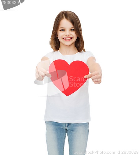 Image of smiling little girl giving red heart