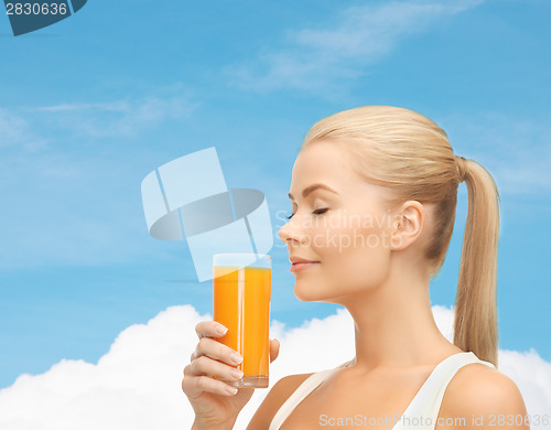 Image of young woman drinking orange juice