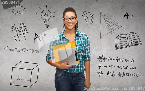 Image of student in eyeglasses with folders and tablet pc