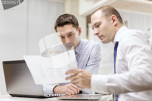 Image of two businessmen having discussion in office