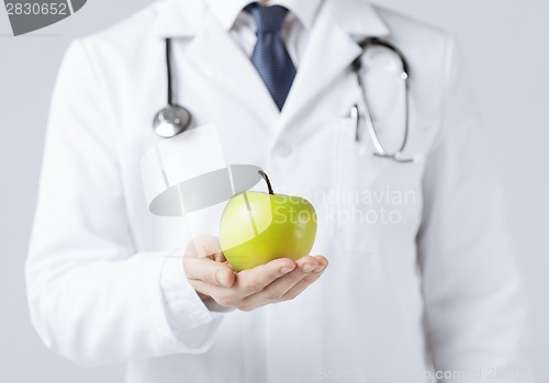 Image of male doctor with green apple