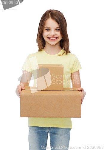 Image of smiling little girl with many cardboard boxes