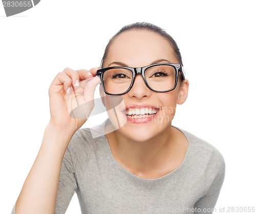 Image of asian woman in adjusting eyeglasses