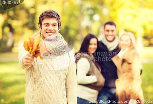 Image of group of friends having fun in autumn park