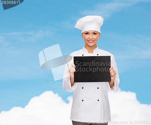 Image of smiling female chef with black blank paper