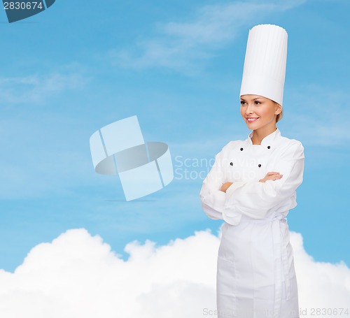 Image of smiling female chef with crossed arms