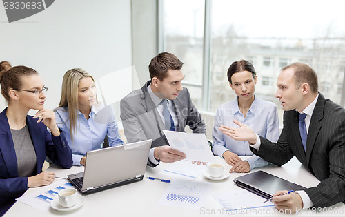 Image of business team with laptop having discussion