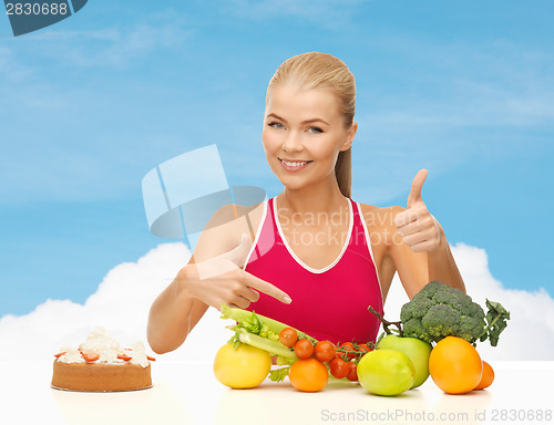 Image of woman pointing at healthy food