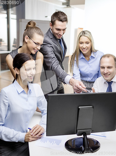 Image of business team with monitor having discussion