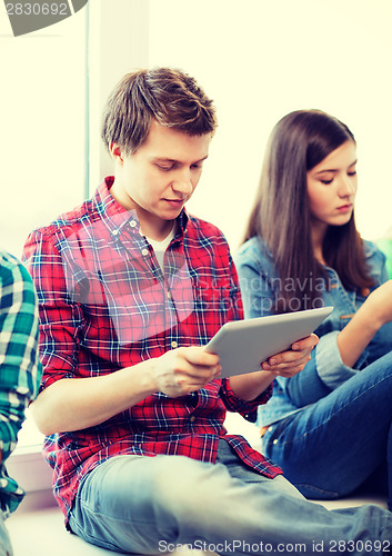 Image of student looking into tablet pc at school