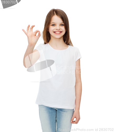 Image of little girl in white t-shirt showing ok gesture