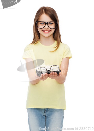 Image of smiling cute little girl in black eyeglasses