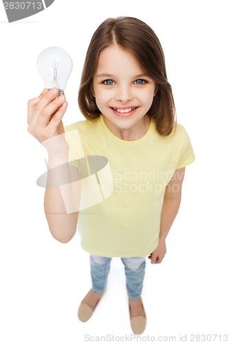 Image of smiling little girl holding light bulb