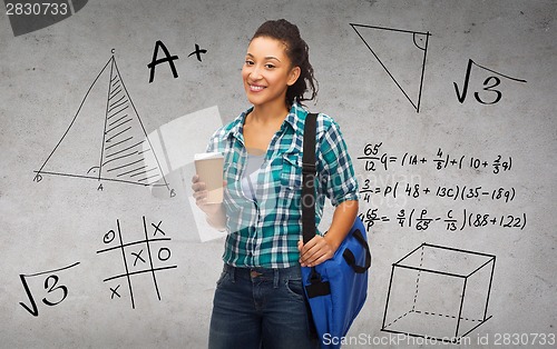 Image of smiling student with bag and take away coffee cup