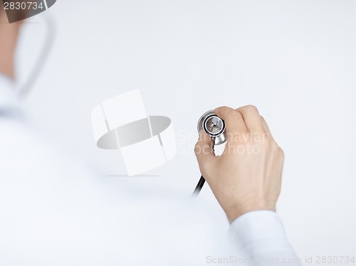 Image of doctor hand with stethoscope listening somebody