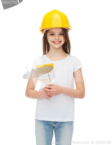 Image of smiling little girl in helmet with paint brush