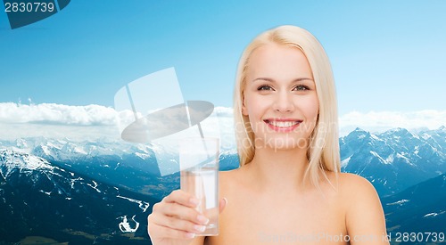 Image of young smiling woman with glass of water