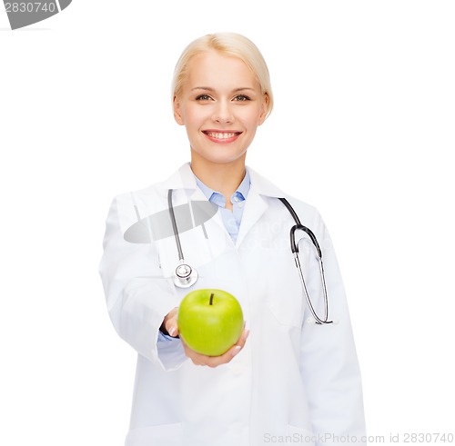 Image of smiling female doctor with green apple