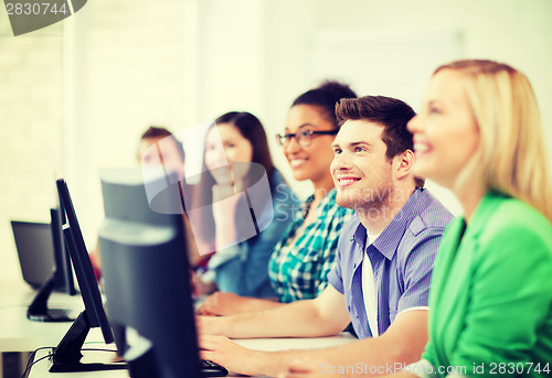 Image of students with computers studying at school