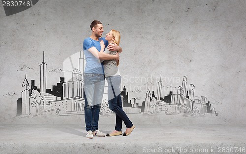 Image of smiling couple hugging and looking at each other