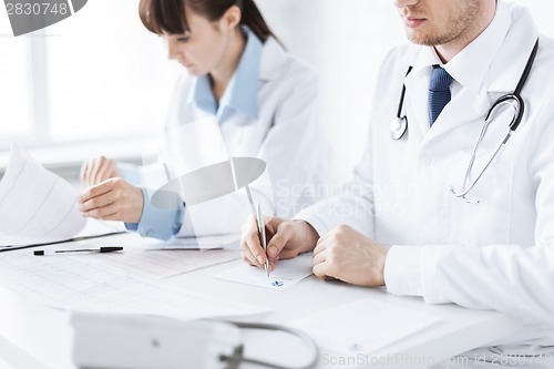 Image of doctor and nurse writing prescription paper