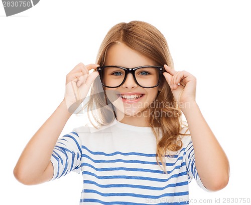 Image of smiling cute little girl with black eyeglasses