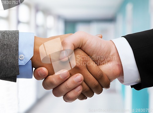 Image of businessman and businesswoman shaking hands