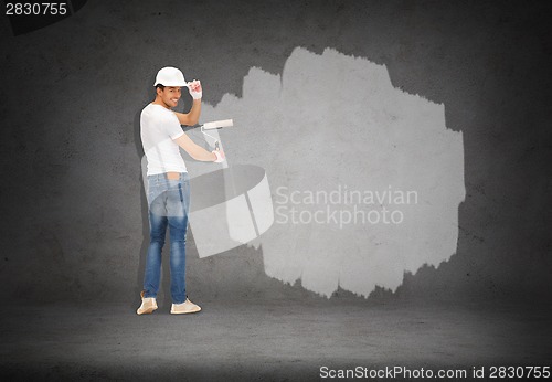 Image of handsome painter in helmet from the back