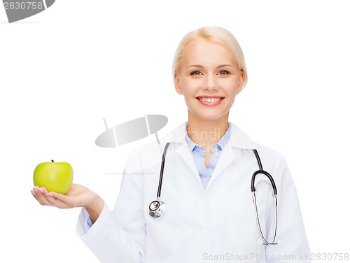 Image of smiling female doctor with green apple