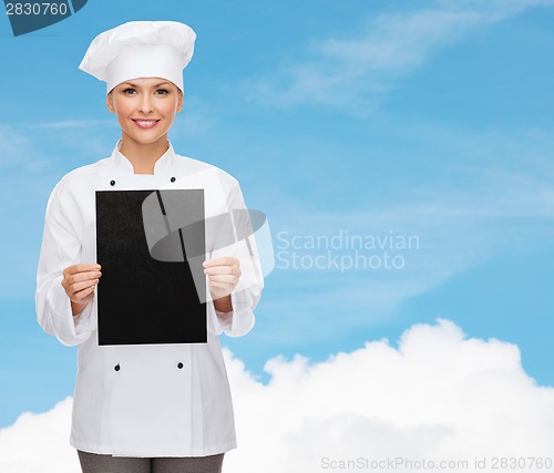 Image of smiling female chef with black blank paper