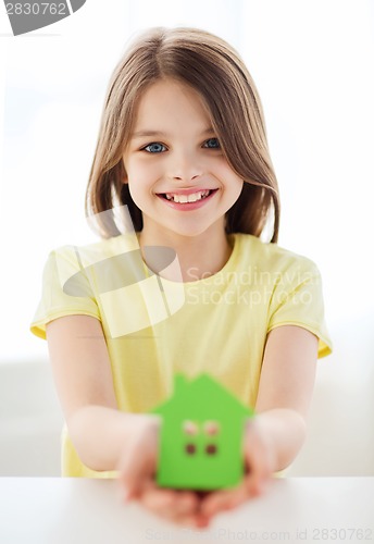 Image of little girl holding green paper house