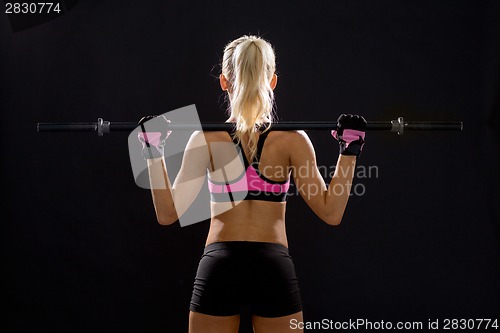 Image of sporty woman exercising with barbell