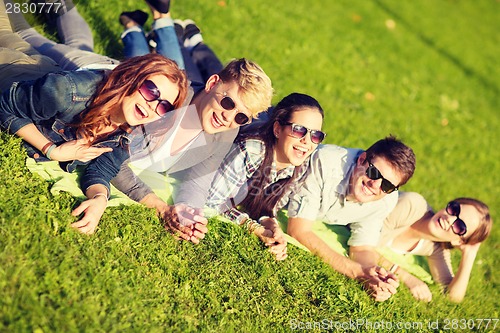 Image of group of students or teenagers lying in park