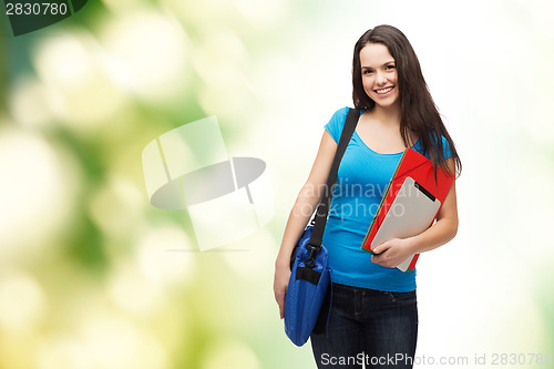 Image of smiling student with bag, folders and tablet pc
