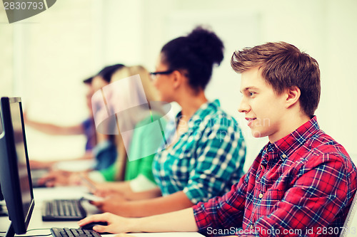 Image of student with computer studying at school