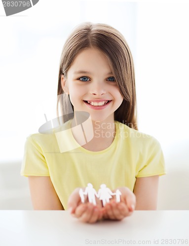 Image of smiling little girl showing paper man family