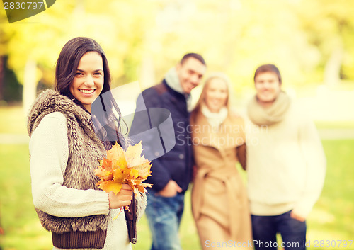 Image of group of friends having fun in autumn park