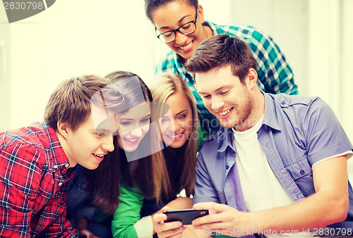 Image of students looking at smartphone at school