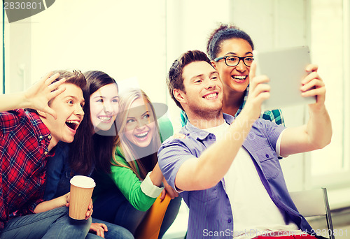 Image of students making picture with tablet pc at school