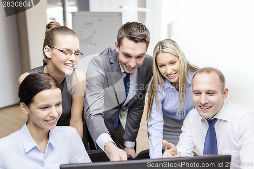 Image of business team with monitor having discussion