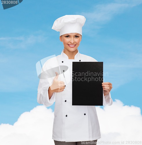 Image of smiling female chef with black blank paper